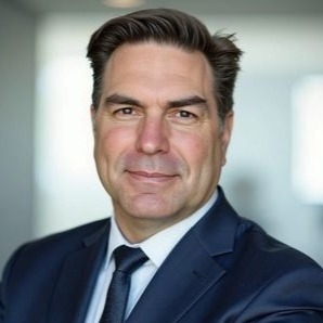 Professional headshot of Todd L. Dietrich, Principal & Co-Founder of AI Governance Advisors, wearing a navy suit and tie.